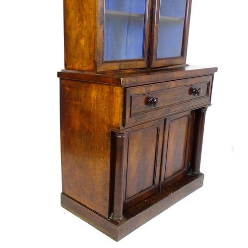 1671 - A 19thC mahogany secretaire bookcase with a moulded top above to glazed doors and three adjustable s... 