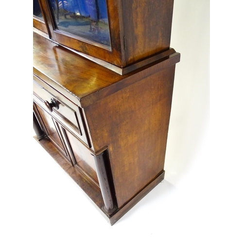 1671 - A 19thC mahogany secretaire bookcase with a moulded top above to glazed doors and three adjustable s... 