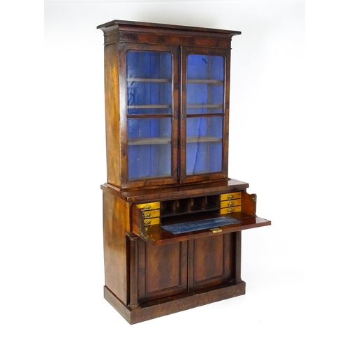 1671 - A 19thC mahogany secretaire bookcase with a moulded top above to glazed doors and three adjustable s... 