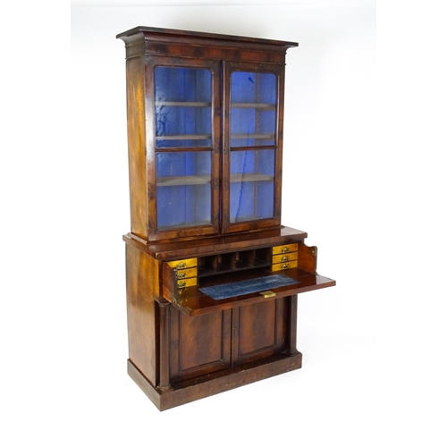 1671 - A 19thC mahogany secretaire bookcase with a moulded top above to glazed doors and three adjustable s... 