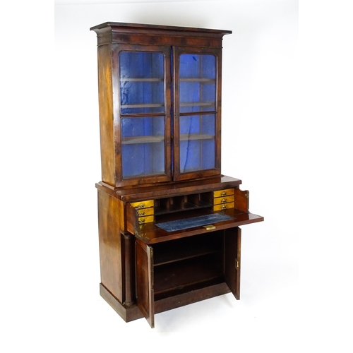 1671 - A 19thC mahogany secretaire bookcase with a moulded top above to glazed doors and three adjustable s... 