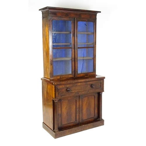 1671 - A 19thC mahogany secretaire bookcase with a moulded top above to glazed doors and three adjustable s... 