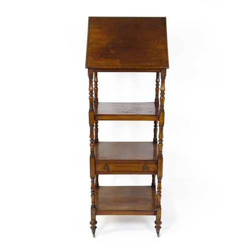 1674 - A 19thC mahogany four tier whatnot with the top tier having an adjustable tilt top, the tiers raised... 