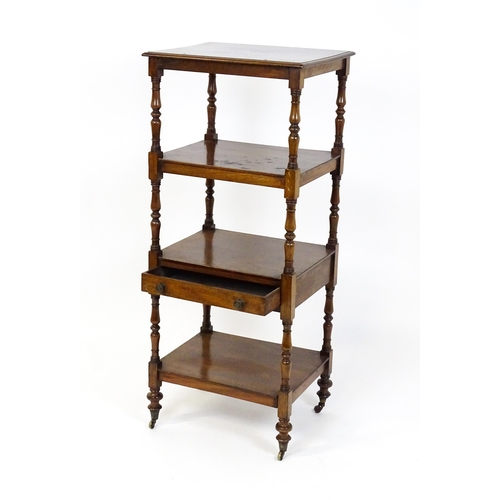 1674 - A 19thC mahogany four tier whatnot with the top tier having an adjustable tilt top, the tiers raised... 