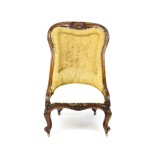 1678 - A 19thC rosewood nursing chair with a moulded frame and carved cresting rail raised on carved cabrio... 