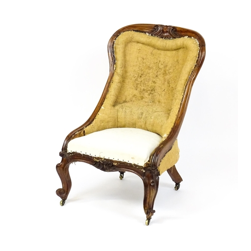 1678 - A 19thC rosewood nursing chair with a moulded frame and carved cresting rail raised on carved cabrio... 