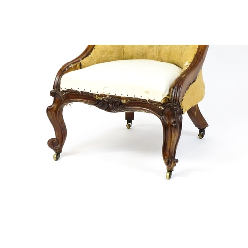 1678 - A 19thC rosewood nursing chair with a moulded frame and carved cresting rail raised on carved cabrio... 