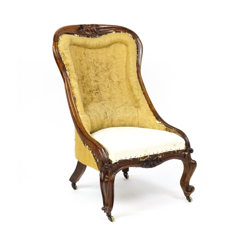 1678 - A 19thC rosewood nursing chair with a moulded frame and carved cresting rail raised on carved cabrio... 