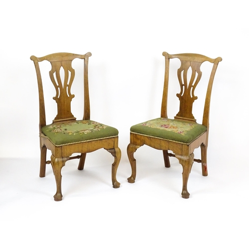 1679 - A pair of George II walnut side chairs with shaped top rails above pierced splats and raised on shap... 