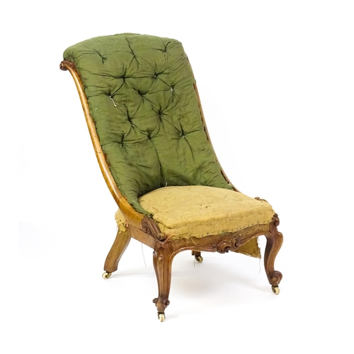 1682 - A Victorian mahogany nursing chair with a scrolled, deep buttoned backrest above carved cabriole fro... 