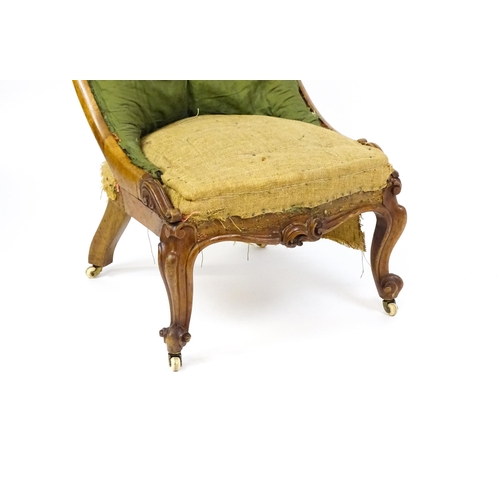 1682 - A Victorian mahogany nursing chair with a scrolled, deep buttoned backrest above carved cabriole fro... 