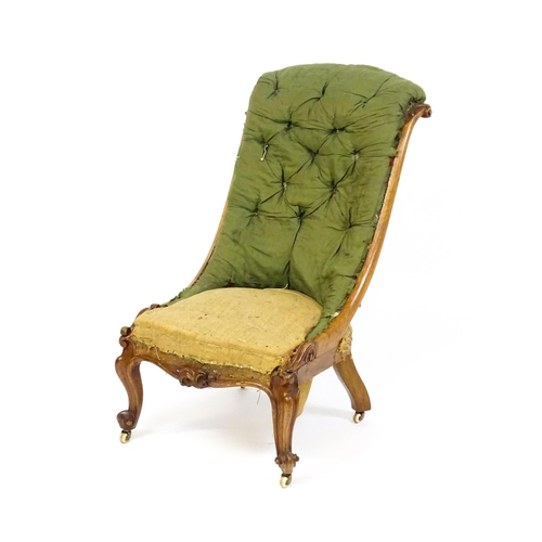 1682 - A Victorian mahogany nursing chair with a scrolled, deep buttoned backrest above carved cabriole fro... 