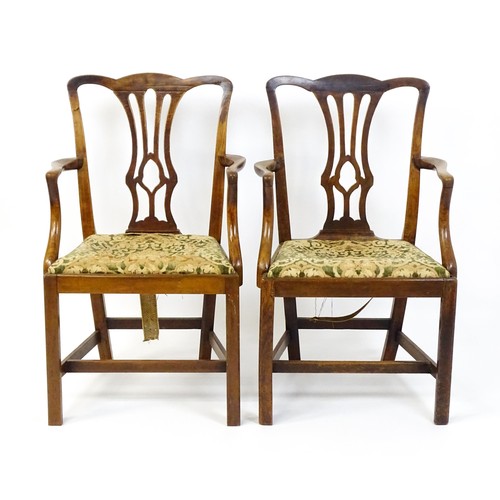 1699 - A pair of late 18thC fruitwood elbow chairs with Chippendale back splats, swept arms, drop in seats ... 