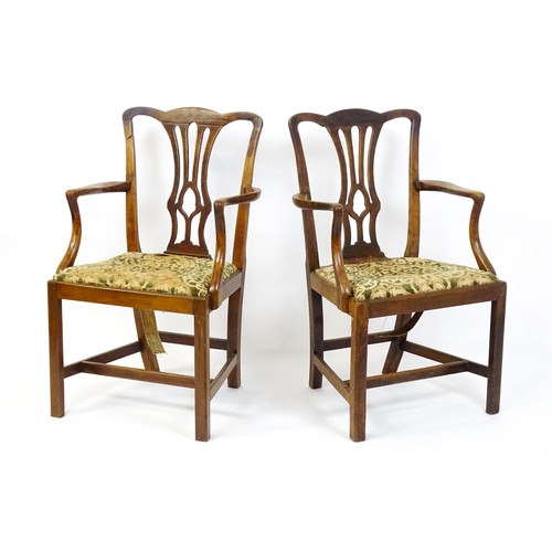 1699 - A pair of late 18thC fruitwood elbow chairs with Chippendale back splats, swept arms, drop in seats ... 