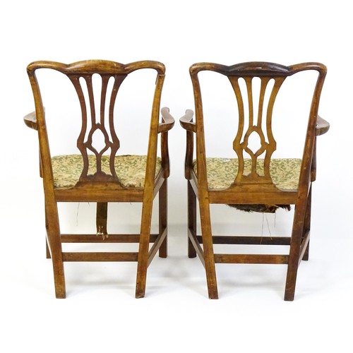 1699 - A pair of late 18thC fruitwood elbow chairs with Chippendale back splats, swept arms, drop in seats ... 