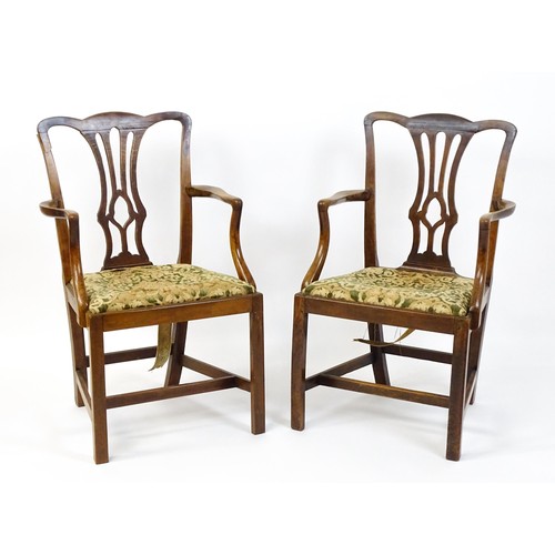 1699 - A pair of late 18thC fruitwood elbow chairs with Chippendale back splats, swept arms, drop in seats ... 