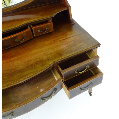 1709 - A late 19thC / early 20thC mahogany Maple & Co dressing table with a decoratively strung mirror abov... 