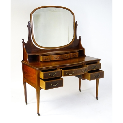 1709 - A late 19thC / early 20thC mahogany Maple & Co dressing table with a decoratively strung mirror abov... 