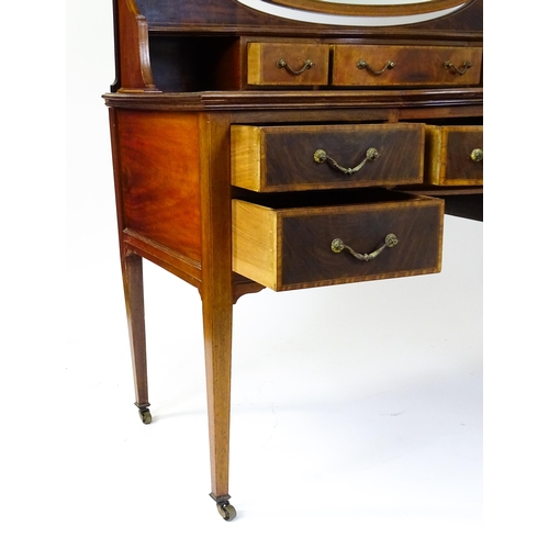 1709 - A late 19thC / early 20thC mahogany Maple & Co dressing table with a decoratively strung mirror abov... 