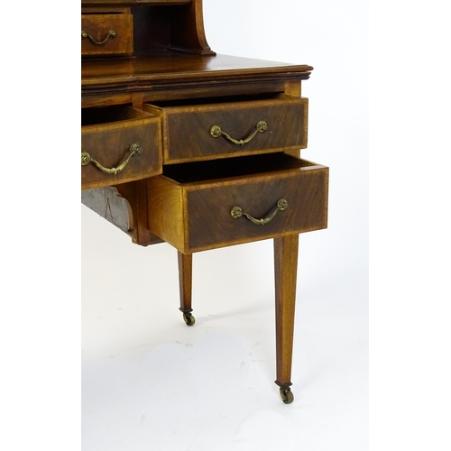 1709 - A late 19thC / early 20thC mahogany Maple & Co dressing table with a decoratively strung mirror abov... 