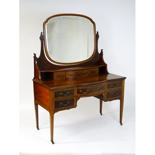 1709 - A late 19thC / early 20thC mahogany Maple & Co dressing table with a decoratively strung mirror abov... 