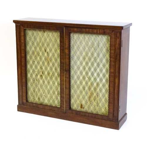 1711 - An early 19thC mahogany cabinet with a rectangular top above two grilled doors fitted with a fabric ... 