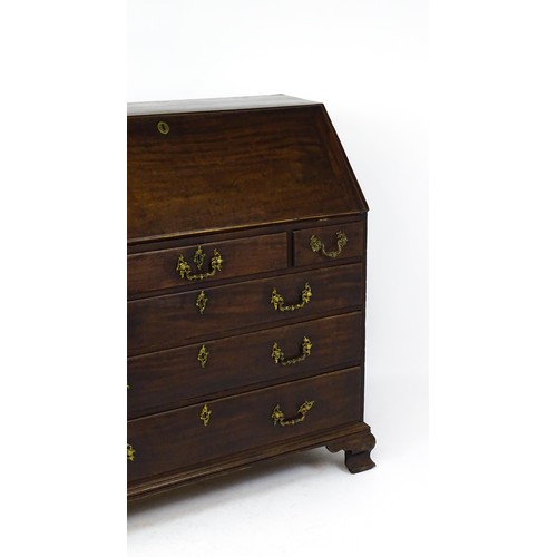 1713 - A late 18thC mahogany bureau with a fall front opening to show a fitted interior with pigeon holes a... 