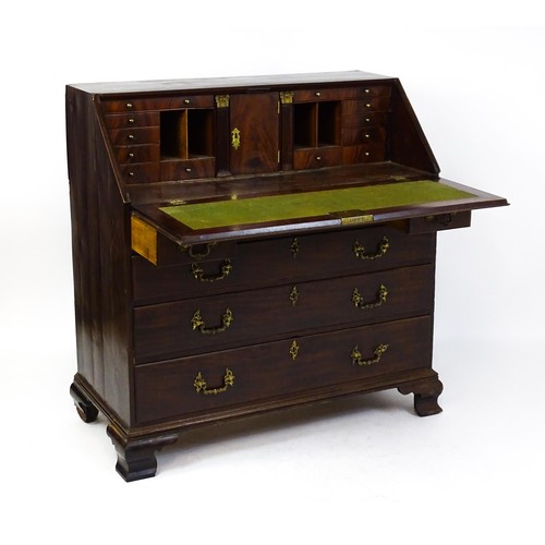 1713 - A late 18thC mahogany bureau with a fall front opening to show a fitted interior with pigeon holes a... 