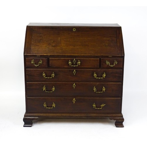 1713 - A late 18thC mahogany bureau with a fall front opening to show a fitted interior with pigeon holes a... 