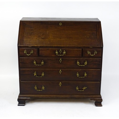 1713 - A late 18thC mahogany bureau with a fall front opening to show a fitted interior with pigeon holes a... 