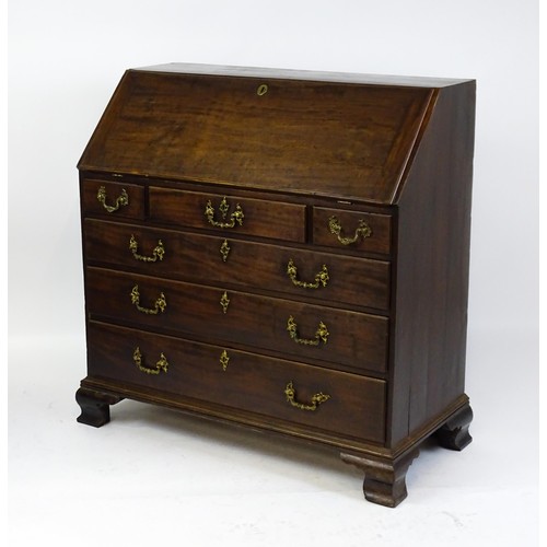 1713 - A late 18thC mahogany bureau with a fall front opening to show a fitted interior with pigeon holes a... 