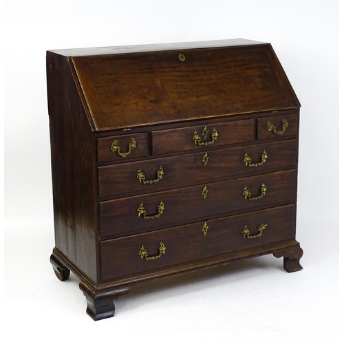 1713 - A late 18thC mahogany bureau with a fall front opening to show a fitted interior with pigeon holes a... 