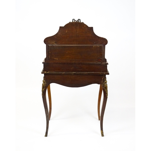 1715 - A 19thC mahogany Bonheur du jour with a shaped and mirrored upstand having marquetry decoration matc... 