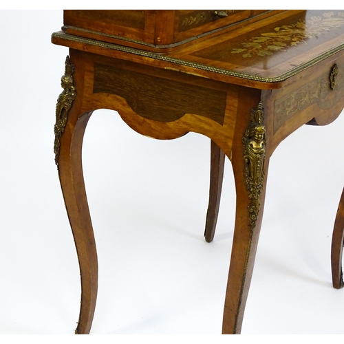 1715 - A 19thC mahogany Bonheur du jour with a shaped and mirrored upstand having marquetry decoration matc... 