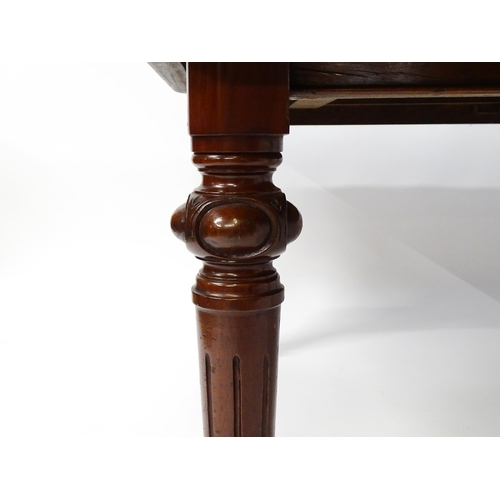 1723 - A 19thC mahogany dining table with a moulded top edge raised on four carved legs raised on four tape... 