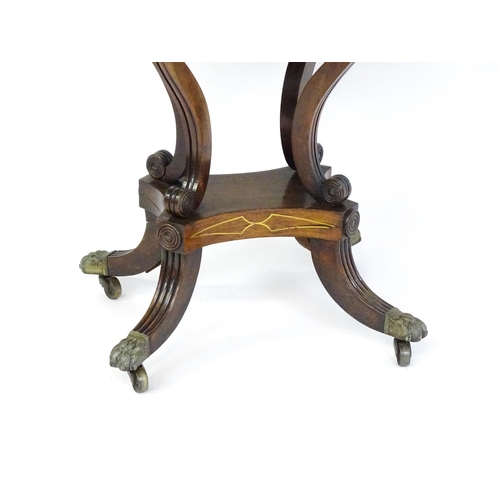 1560 - A Regency rosewood card table with inlaid brass stringing, the revolving top opening to show a baize... 