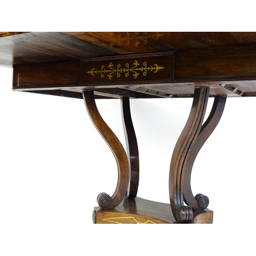 1560 - A Regency rosewood card table with inlaid brass stringing, the revolving top opening to show a baize... 