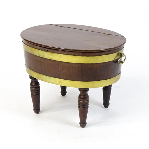 1561 - An early 19thC mahogany cellarette with a hinged lid above brass coopering and flanked by carrying h... 