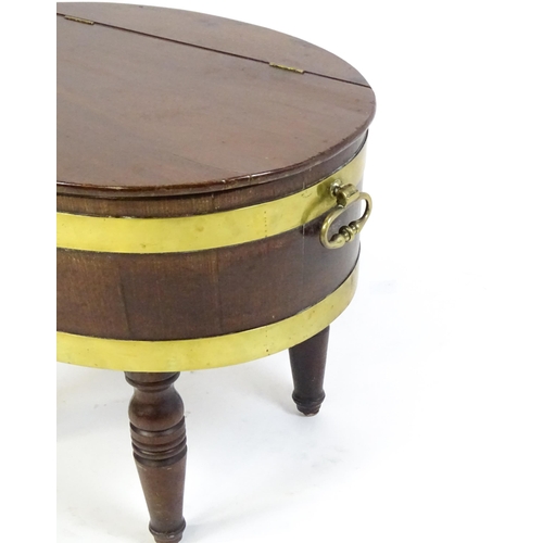 1561 - An early 19thC mahogany cellarette with a hinged lid above brass coopering and flanked by carrying h... 