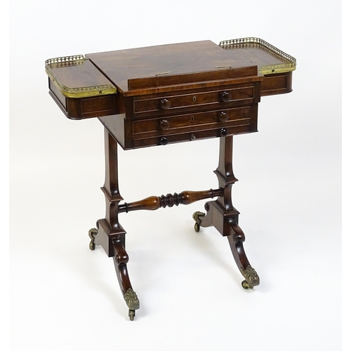 1562 - A Regency rosewood work / games table with a brass gallery above two short drawers. The top having a... 