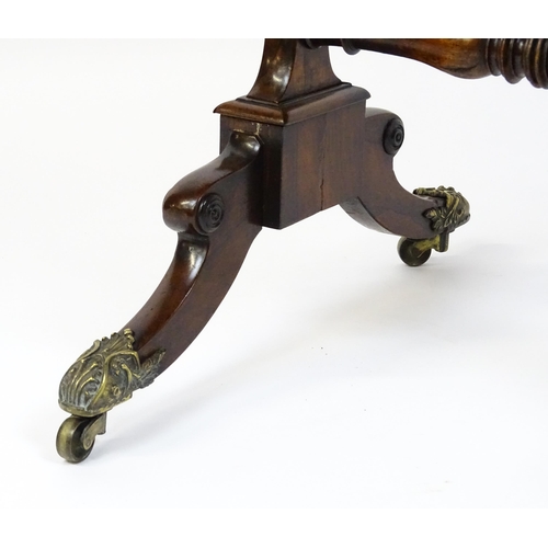 1562 - A Regency rosewood work / games table with a brass gallery above two short drawers. The top having a... 