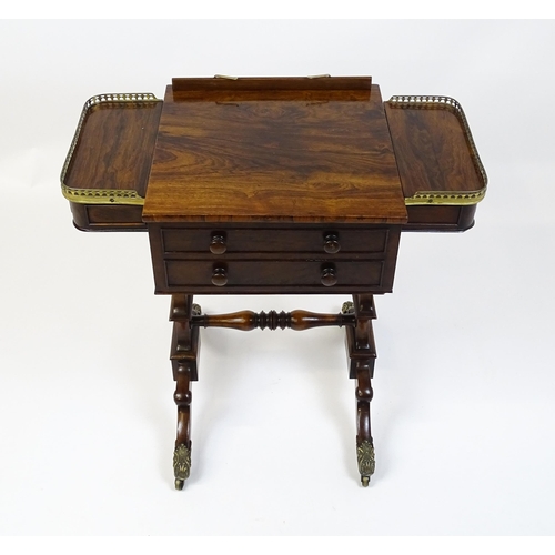 1562 - A Regency rosewood work / games table with a brass gallery above two short drawers. The top having a... 