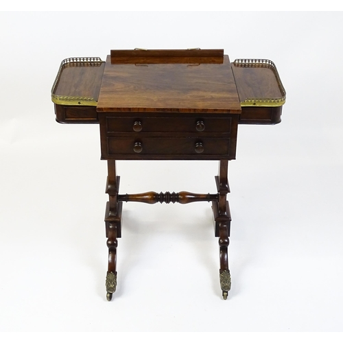 1562 - A Regency rosewood work / games table with a brass gallery above two short drawers. The top having a... 