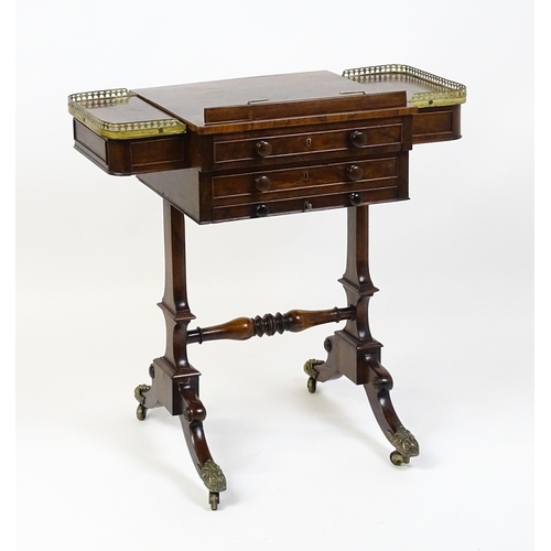 1562 - A Regency rosewood work / games table with a brass gallery above two short drawers. The top having a... 