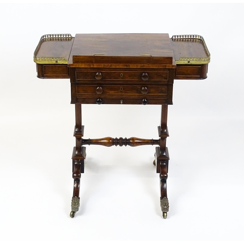 1562 - A Regency rosewood work / games table with a brass gallery above two short drawers. The top having a... 