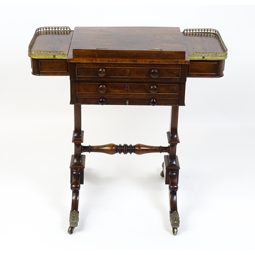 1562 - A Regency rosewood work / games table with a brass gallery above two short drawers. The top having a... 