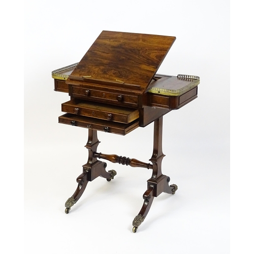 1562 - A Regency rosewood work / games table with a brass gallery above two short drawers. The top having a... 