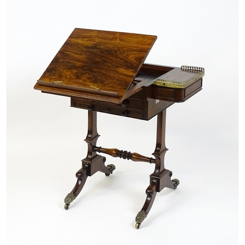 1562 - A Regency rosewood work / games table with a brass gallery above two short drawers. The top having a... 