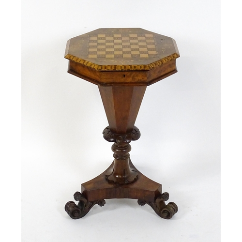 1563 - A Victorian walnut trumpet shaped work table / sewing table with an inlaid octagonal top raised on t... 