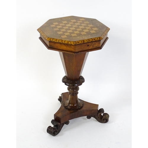 1563 - A Victorian walnut trumpet shaped work table / sewing table with an inlaid octagonal top raised on t... 